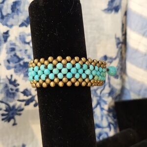 Turquoise and brassy gold colored beaded bracelet
